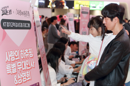KT가 9일 롯데시네마 월드타워점에서 유무선 장기이용자 500가족을 초청해 '초대드림' 이벤트 '사랑의 하츄핑' 특별 상영회를 진행했다. 이날 행사에 참여한 이용자 가족이 사진을 찍고 있다.   KT 제공